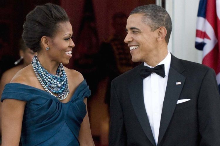 U.S. President Barack Obama and first lady Michelle Obama talk as they wait to receive Britain's Prime Minister David Cameron and his wife Samantha as they arrive for an official dinner in their honor at the White House in Washington, March 14, 2012. REUTERS/Jonathan Ernst (UNITED STATES - Tags: POLITICS)