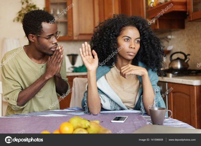 Male begging his girlfriend to forgive him. – Stock Image
