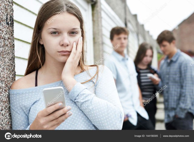 Teenage Girl Victim Of Bullying By Text Messaging – Stock Image