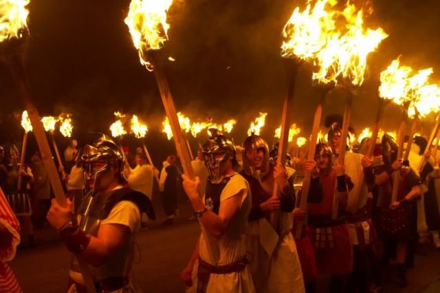 Warga mengenakan kostum prajurit viking dan membawa obor