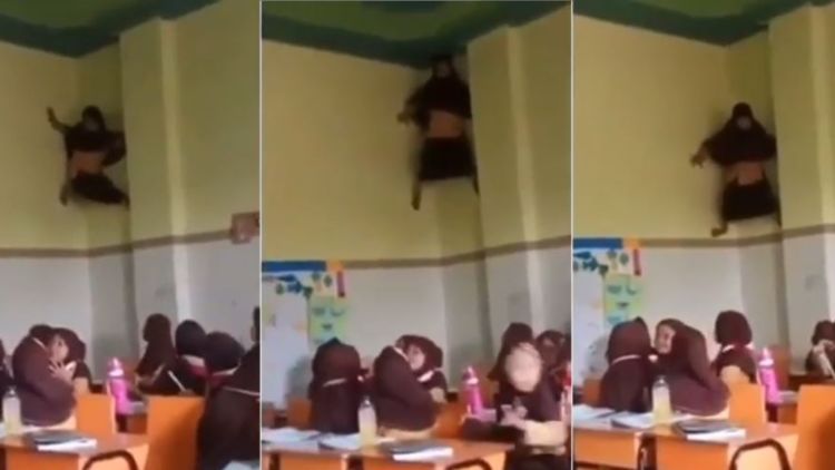 6 Hal yang Mungkin Jadi Alasan Gadis Viral ini Nemplok di Tembok Kelas. Hobi Manjat Apa Gimana sih?