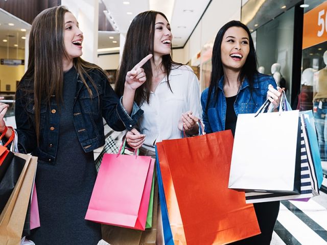 Pretty girls exploring shops in mall