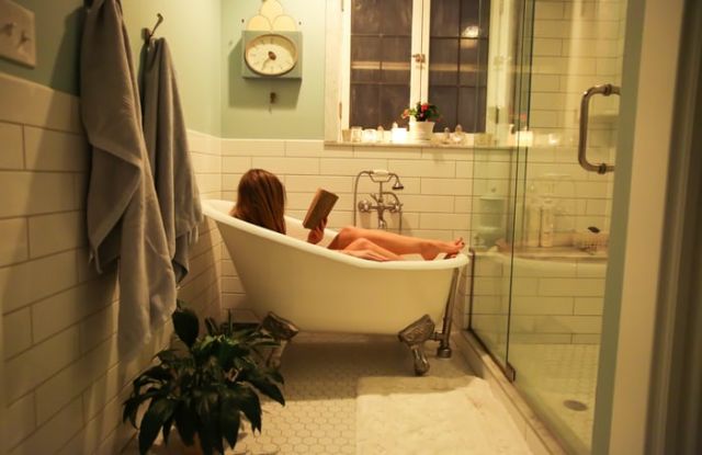 Person in white ceramic bathtub by Ava Sol