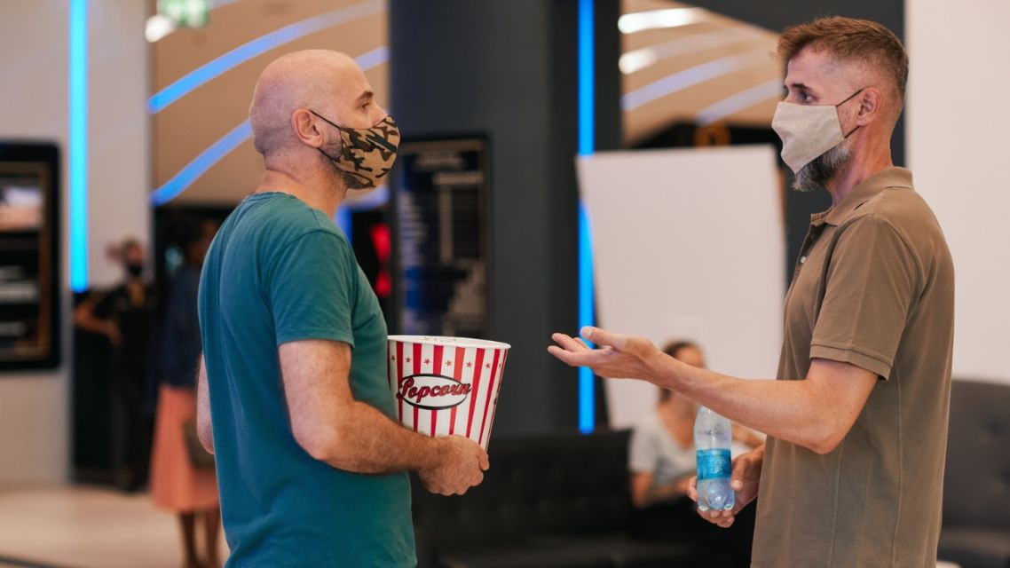 Why a Bad Movie Can Be the Best Way to Start Talking to Someone New 5 strangers talking about bad movies outside a cinema